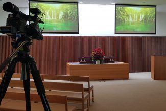 The lifeMemorials team is set up and live streaming a funeral service